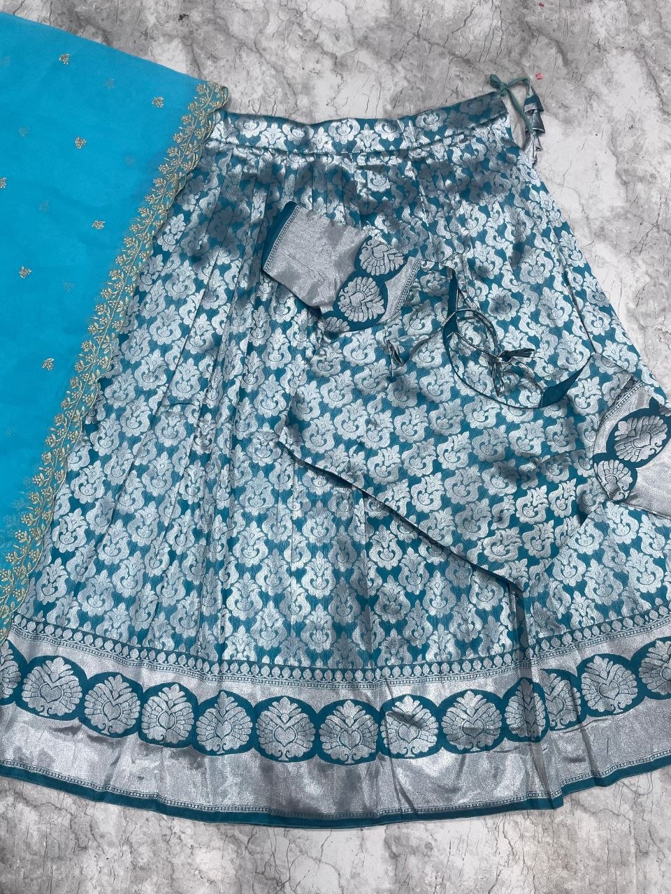 Exquisite Silver Zari work on a classic Teal Silk Lehenga