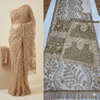 A luxurious ochre gold net saree adorned with dense floral embroidery