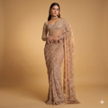A luxurious ochre gold net saree adorned with dense floral embroidery